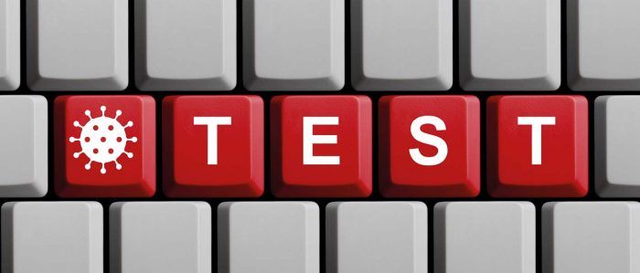 Computertastatur mit den Tasten „Test“ und einem Corona-Symbol
